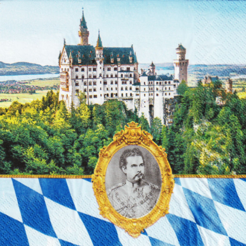 Die Serviette ist unterteilt. Im oberen Teil ist das Schloss Neuschwanstein zu sehen in der Landschaft. Der untere Teil besteht aus weiß-blauen Rauten. In der Mitte des unteren Teils ist eine goldgerahmte Vignette von König Ludwig II zu sehen.